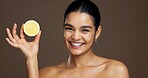 Beauty, woman and portrait with lemon in studio for natural skincare, dermatology or vitamin c on background. Healthy glow, citrus fruit and sustainable antiaging with clean skin or self care