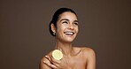 Happy woman, lemon or skincare with vitamin C in studio for detox on a brown background. Female person, model or smile with natural organic fruit or diet for citrus acid, health and collagen on space