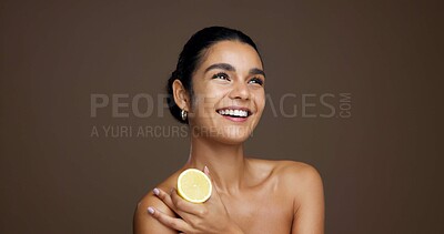 Buy stock photo Happy woman, lemon or skincare with vitamin C in studio for detox on a brown background. Female person, model or smile with natural organic fruit or diet for citrus acid, health and collagen on space