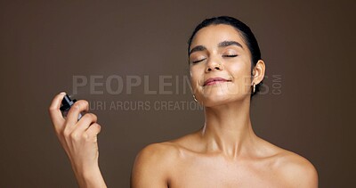 Buy stock photo Woman, beauty and setting spray for makeup, cosmetology or skincare in studio with cosmetic product. Skin, glow and spritz for primer or facial mist with bottle in hand isolated on brown background