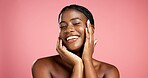 Beauty, woman and smile with skincare in studio for glow, collagen treatment or skin regeneration. Mockup space, black girl and cosmetics results with face hydration and self care on pink background