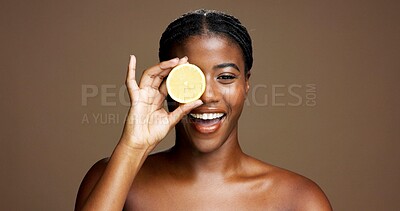 Buy stock photo Happy, black woman and portrait with lemon for skincare or health on a brown studio background. Face, female person or model with smile or natural organic fruit for vitamin C, diet or citrus acid