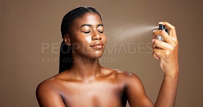 Buy stock photo Beauty, cosmetics and setting spray with black woman in studio for facial or makeover product. Face, finishing mist and makeup with African model isolated on brown background for cosmetology