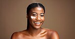 Cream, beauty and portrait of black woman in studio for skincare product, cosmetics and dermatology. Glow, hyaluronic acid and self care with person and lotion on brown background space for retinol