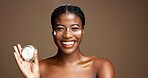 Cream, skincare and smile with portrait of black woman in studio for beauty, cosmetics or dermatology. Glow, hyaluronic acid and self care with person and lotion on brown background space for retinol