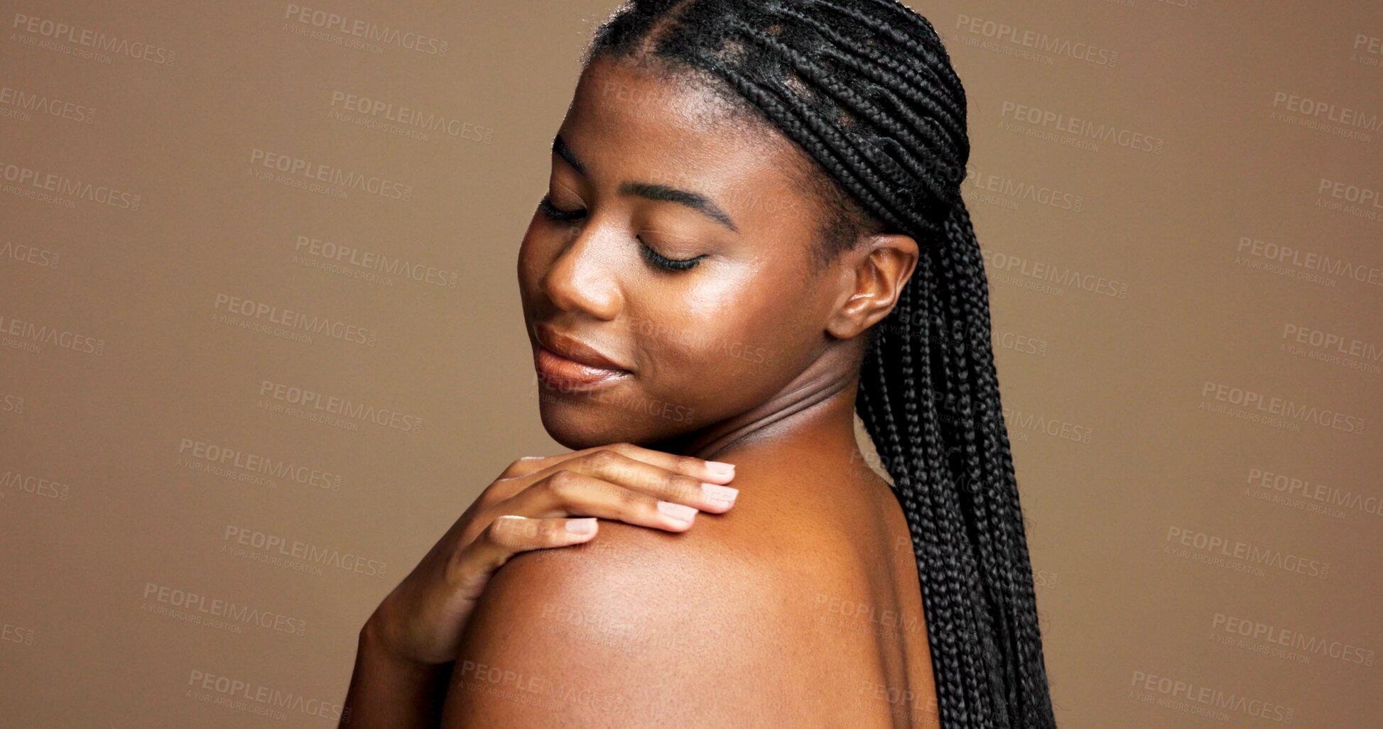 Buy stock photo Black woman, shoulder and studio with skincare for hygiene or dermatology on a brown background. Female person, model or touch with smile, texture or smooth skin for glow or shine on mockup space