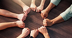 People, hands or circle with fist for team building, unity or mission together above. Top view, group or community with solidarity, trust or support for social inclusion, connection or cohesion