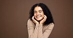 Beauty, smile and hands with woman in studio for natural makeup, glow and self care. Happiness, shine and aesthetic with female person on brown background space for dermatology and hydration