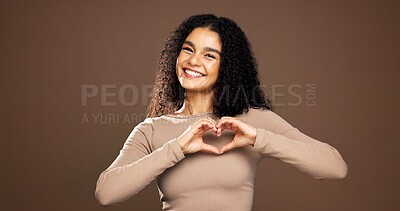 Buy stock photo Heart hands, smile and portrait of woman in studio for support, kindness and thank you. Gratitude, happiness and emoji sign with person on brown background space for love gesture and care symbol