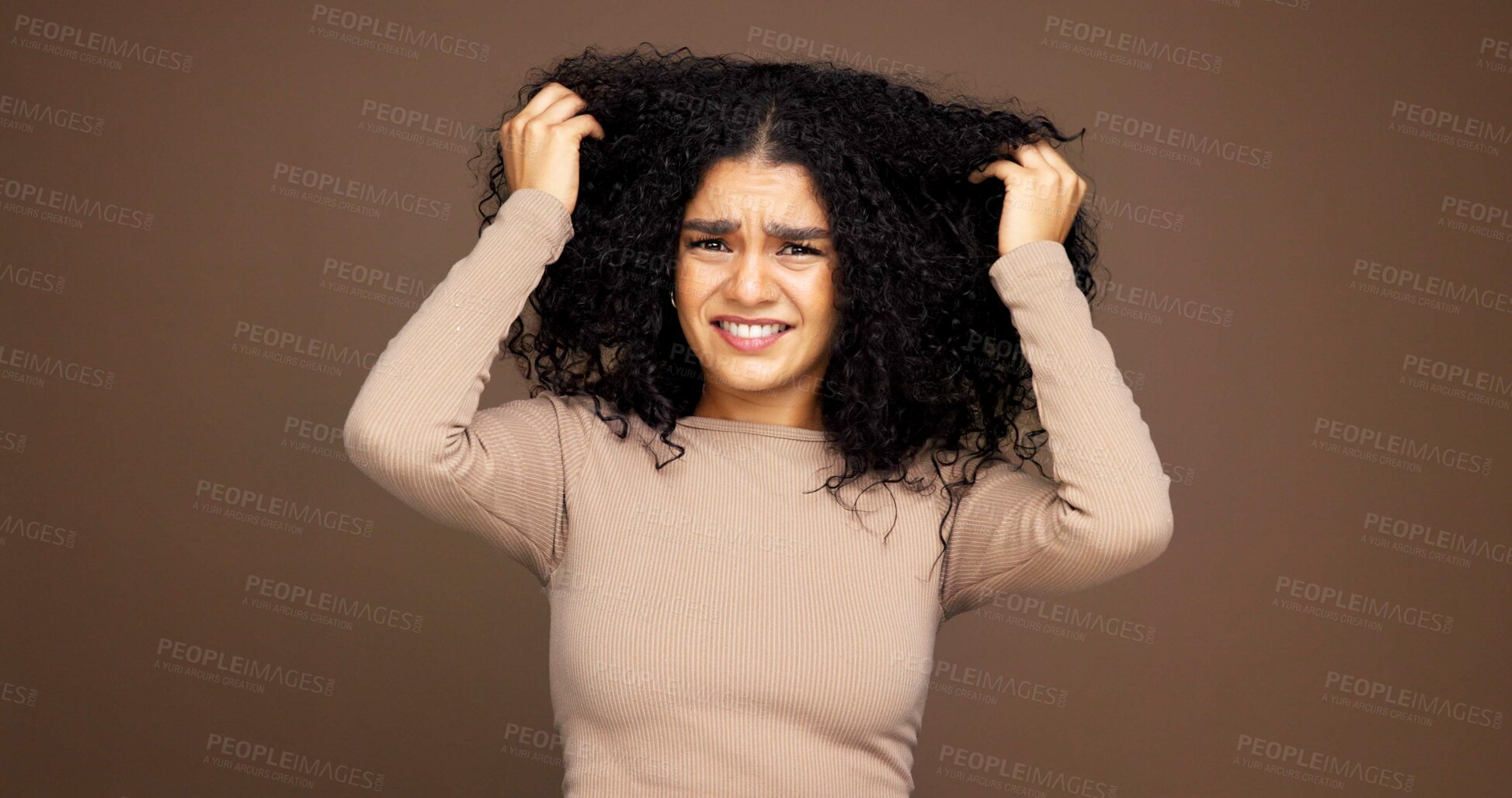 Buy stock photo Mistake, hair and portrait of woman in studio with frizz problem, dry texture and damage. Hairdresser, salon and person worried for haircare treatment, curly routine and grooming on brown background
