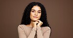Makeup, portrait and woman in studio for cosmetics, beauty or facial glow with glamour. Smile, natural and female person from Colombia with face cosmetology for confidence by brown background.