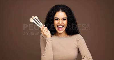 Buy stock photo Beauty, excited or woman with makeup brushes in studio for concealer, skincare product or self care. Mockup, beautician and portrait with cosmetics tools on brown background for contour or foundation