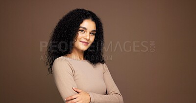 Buy stock photo Portrait, hair care and confident woman with glow in studio, growth or texture on brown background. Curly hairstyle, happy model and beauty cosmetics for hairdresser with arms crossed on mockup space