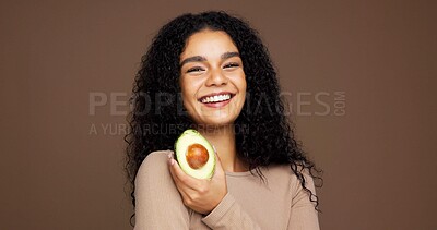 Buy stock photo Beauty, woman and portrait with avocado in studio for skincare glow, vitamin c or skin elasticity. Mockup space, person and happy with fruit on brown background for natural antioxidants and hydration