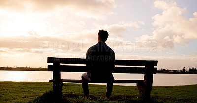 Buy stock photo Man, thinking or back view with sunset on bench at lake for daydreaming, memory or break in nature. Male person, relax and fresh air with cloudy sky for rest, contemplating or travel at river or pond