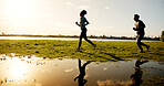 Fitness, running and sunset with couple outdoor at lake in nature for cardio training on space. Exercise, field and reflection with people on grass in park together for health, wellness or workout