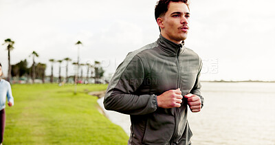 Buy stock photo Man, fitness or running with grass field at lake for workout, cardio exercise or training in nature. Active, male person or runner in sprint for race, marathon or physical activity at pond or river