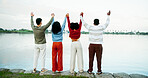 Travel, friends or hands raised with celebration at lake for trip destination, view or support. Back, group or people with freedom in nature for winter getaway, bonding together or vacation adventure