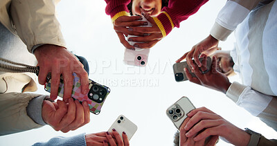 Buy stock photo People, hands and network with phone below in circle for social media, data sync or sharing app. Low angle, group or community with mobile smartphone for online texting, connection or global research
