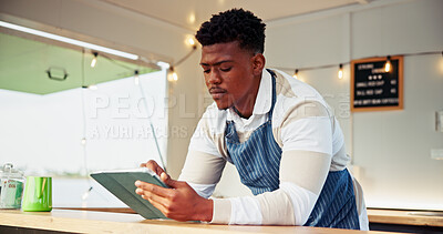 Buy stock photo Black man, owner and reading on tablet at food truck for online order, inventory update and event planning. Male person digital and review price list, menu checklist and vendor application of startup