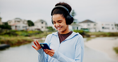 Buy stock photo Headphones, fitness or happy woman in lake with phone for workout, tracking exercise or song. Results, smile or athlete runner on mobile in city for running progress, music playlist or podcast audio