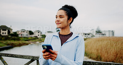Buy stock photo Thinking, fitness or woman with phone on bridge for exercise break, training app or monitor progress. Athlete, runner and girl with smartphone in nature for tracking running speed and workout update