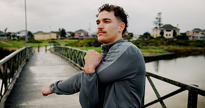 Buy stock photo Exercise, stretching and thinking with man on bridge for start of morning cardio routine. Fitness, getting ready and warm up with athlete outdoor in nature park for running, training or workout