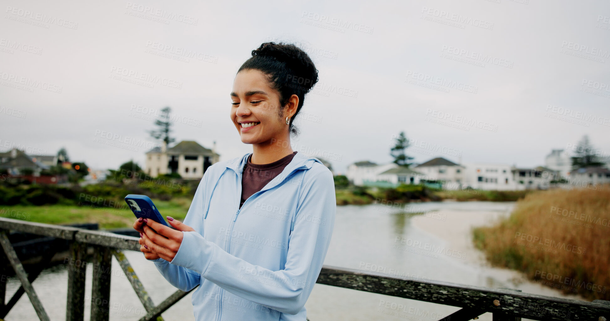 Buy stock photo Exercise, break and woman with phone on bridge for fitness app, check stats or running performance. Space, runner and happy with smartphone in nature for cardio progress, workout and training timer