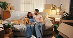 Couple, dog and relax on sofa in new home for mortgage success, security and bonding together. Night, people and moving in to pet friendly house with relocation, property investment and achievement