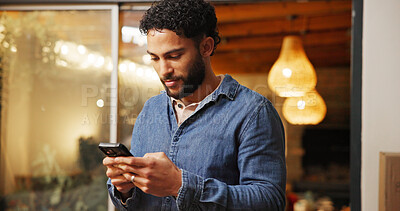 Buy stock photo Phone, smile and man in coffee shop with networking, communication or connectivity in mobile app. Cellphone, texting and male person on blog for restaurant review on website in cafe or diner.