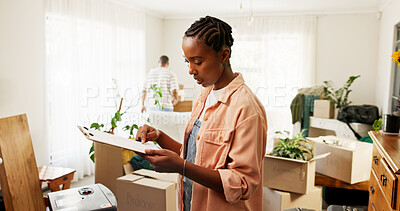 Buy stock photo Clipboard, moving and black woman in new home for information on renovations or interior design. Living room, cardboard boxes and female person with checklist for planning maintenance in house.