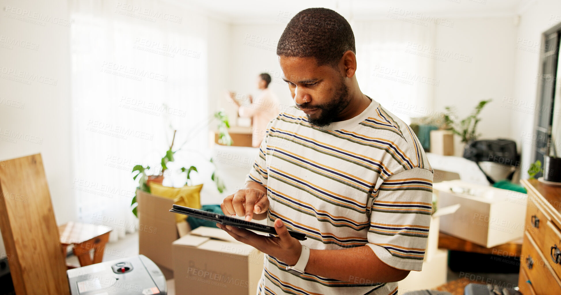 Buy stock photo Tablet, moving and hands of man in new home for research on renovations, interior design or online shopping. Digital technology, cardboard boxes and male person on app for ecommerce purchase in house