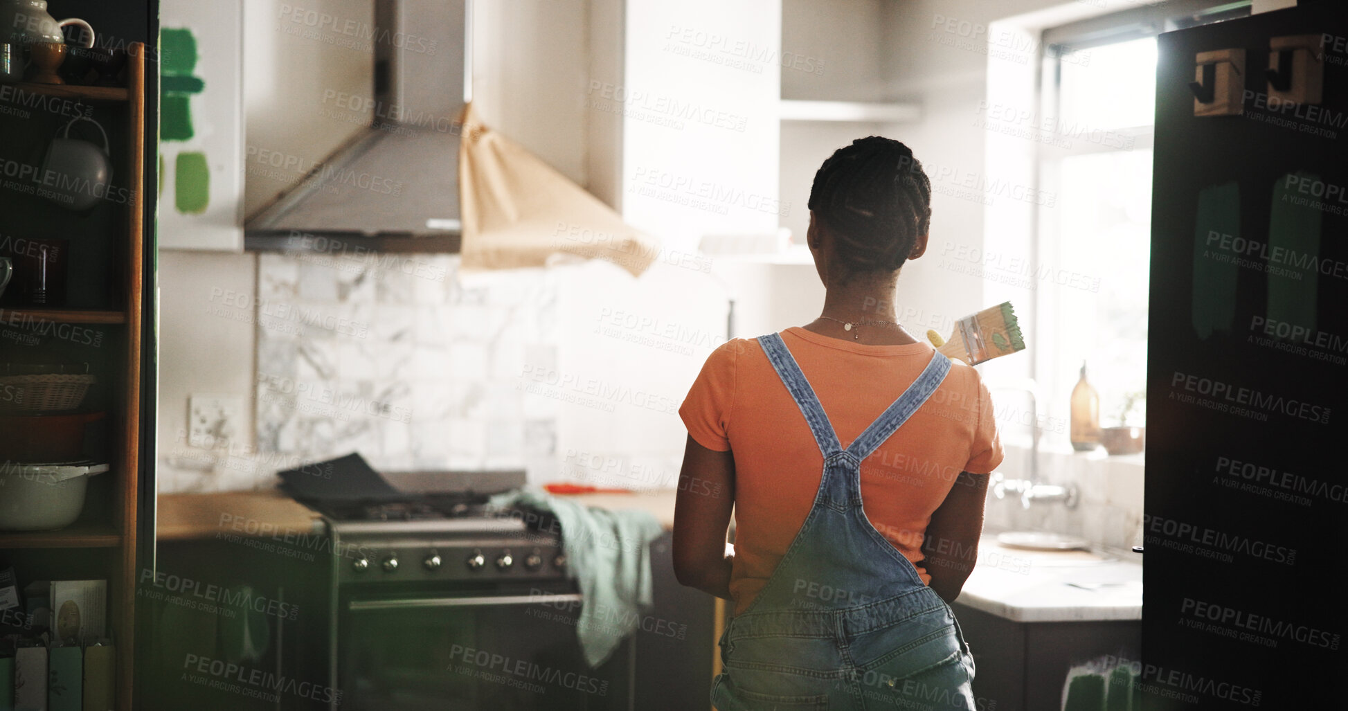 Buy stock photo DIY, paintbrush and thinking with black woman in kitchen of new house for maintenance from back. Painting, real estate and restoration with homeowner person in apartment for development or renovation