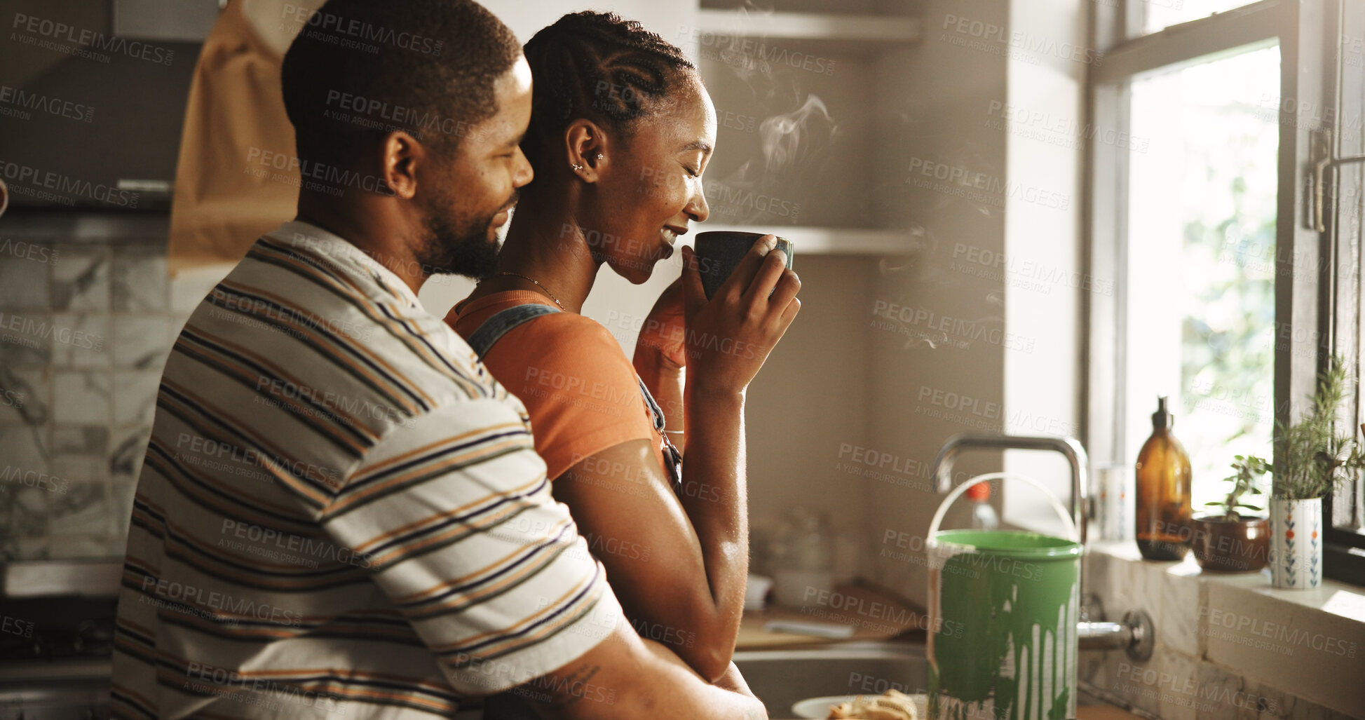 Buy stock photo Home renovation, paint and couple with coffee, hug or romance on break in kitchen, love and morning. Happy, black man and woman with caffeine, bonding or remodeling of new house, color or maintenance