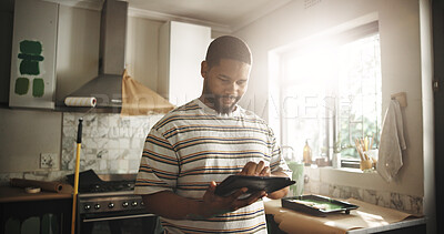 Buy stock photo Painting, tablet and man in home for renovation, interior design and online shopping for supplies. Technology, remodeling kitchen and African person research for house improvement with creative ideas