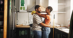 Painting, dance and happy couple in home for love, remodeling and bonding together with care. Renovation, man and African woman with music in kitchen to celebrate house upgrade, romance and embrace