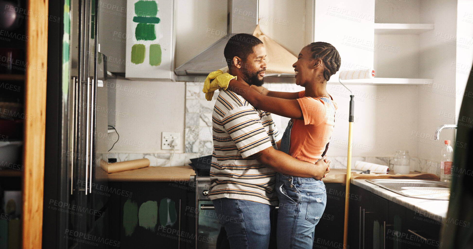 Buy stock photo Painting, dance and happy couple in home for love, remodeling and bonding together with care. Renovation, man and African woman with music in kitchen to celebrate house upgrade, romance and embrace
