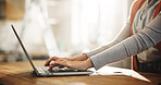 Hands, laptop and typing with employee in home office for planning, remote work or research. Computer, small business and startup with freelance person at desk in study of apartment for report