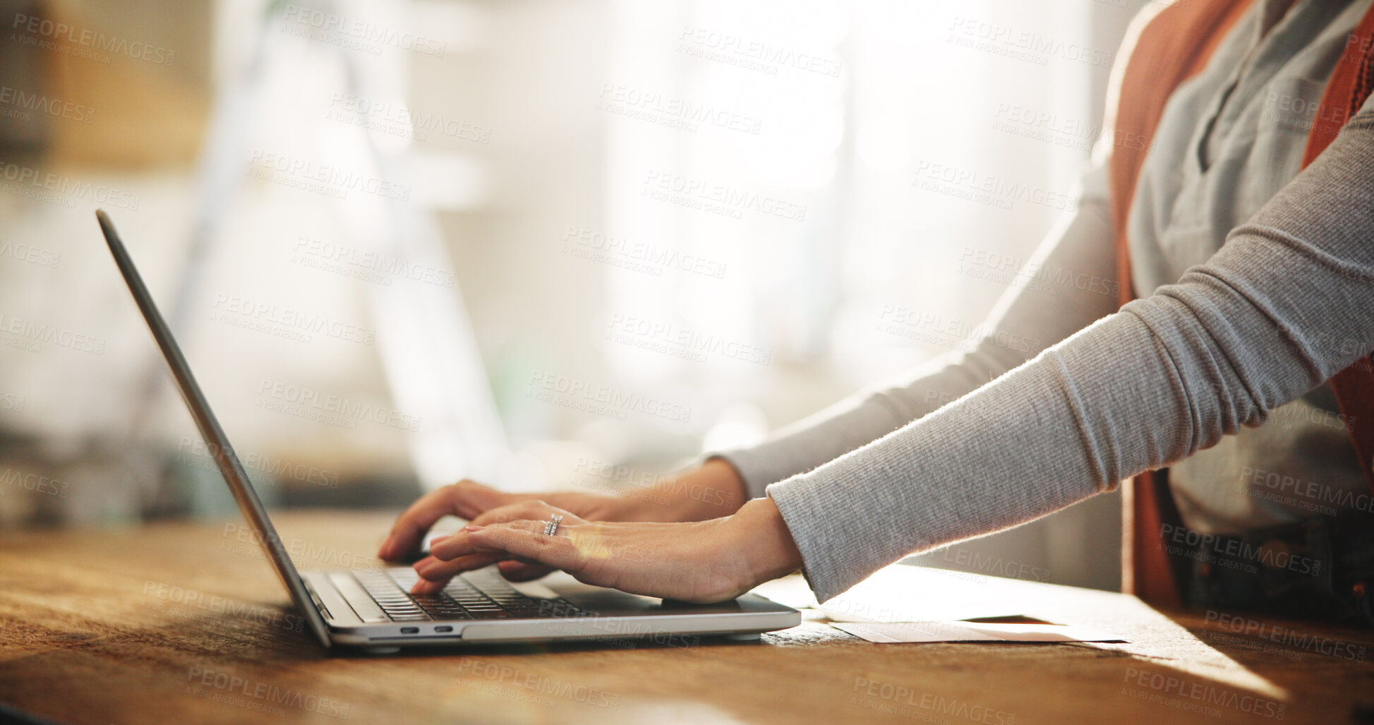 Buy stock photo Hands, laptop and typing with employee in home office for planning, remote work or research. Computer, small business and startup with freelance person at desk in study of apartment for report