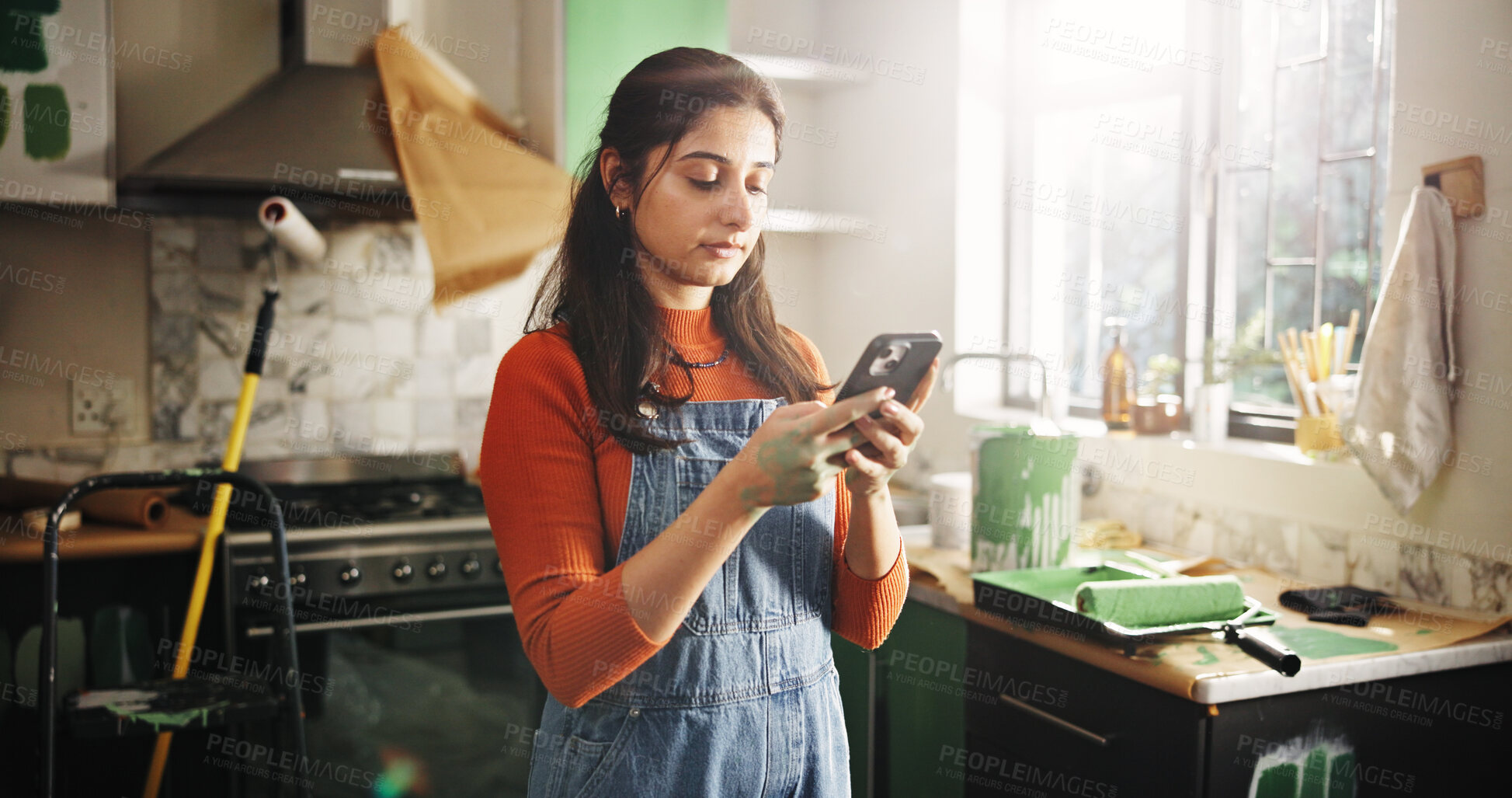 Buy stock photo DIY, phone and renovation with woman in kitchen of apartment to search for home improvement ideas. App, communication and maintenance with person in new house for interior design or online planning