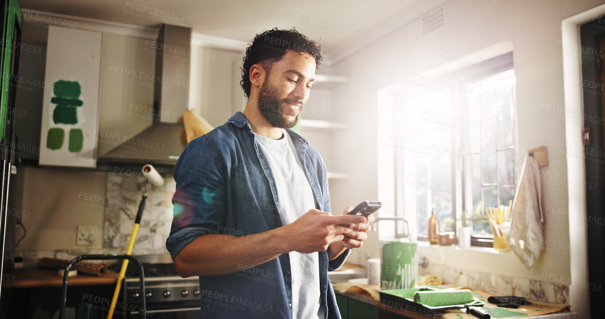 Buy stock photo DIY, phone and renovation with man in kitchen of apartment to search for home improvement ideas. App, communication and maintenance with homeowner in new house for interior design or online planning