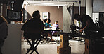 Production, man and director in studio with back view for film, shooting movie and media on set. Behind the scenes, people and camera crew for direction, videography and recording for cinematography