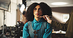 Woman, actress and makeup artist with brush in studio preparation for production on set. Female person, model and beauty with crew getting ready for character, film making or acting behind the scenes