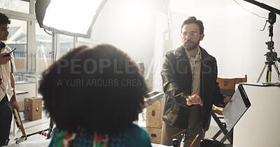 Buy stock photo Set, man and director with script, talking and explaining scene to actor, entertainment or creative. Production, people and filmmaker with lines for direction, crew and instructions for movie or take