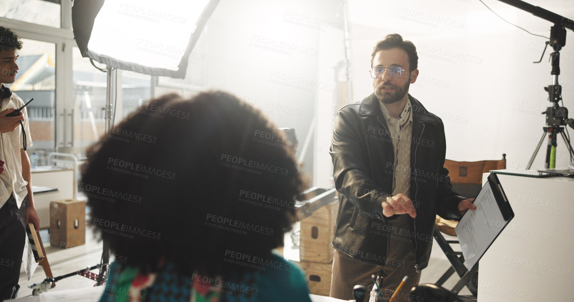 Buy stock photo Set, man and director with script, talking and explaining scene to actor, entertainment or creative. Production, people and filmmaker with lines for direction, crew and instructions for movie or take