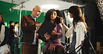 People, actress and filming with clipboard on set for scene notes, feedback and director advice. Team, makeup and preparation with supervisor for movie production, performance guide and script lines