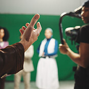 Video Performance Directions Director, hands and instructions to crew on set for creative advice ...