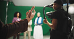 Director, hands and instructions to crew on set for creative advice, cast direction and guidance. Videography, filming team and people with green screen for movie production and performance feedback