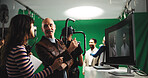 People, director and producer with scene in studio with cameraman for action, playback or recording. Man, woman or production team with assistant crew for preview, film making or green screen in set