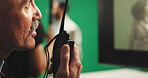 Man, film director or radio with green screen for action, scene or instruction in production studio. Male person, producer or manager talking with signal cut for take, cue or special effects in set